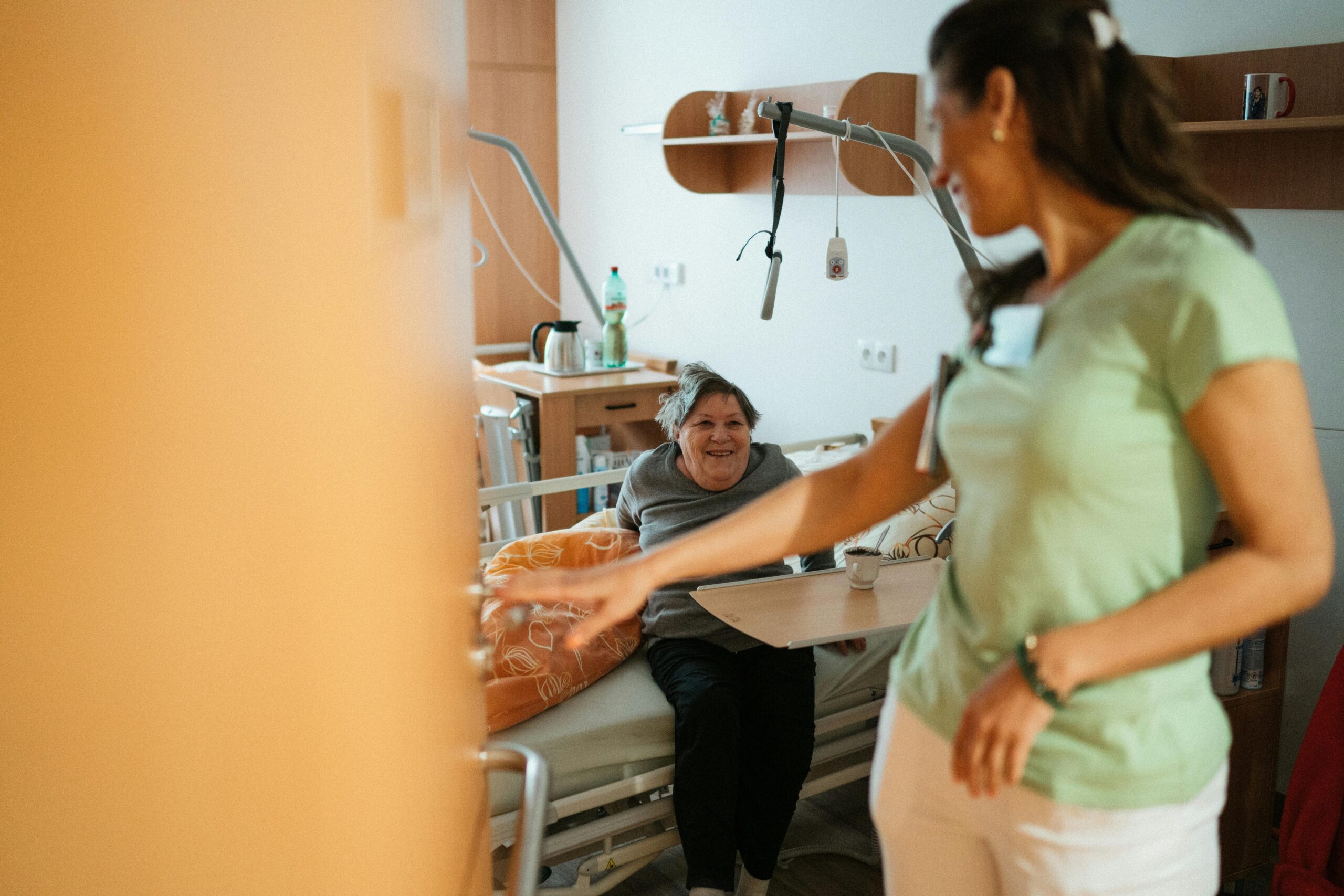Image of a nurse checking on a resident in their private room